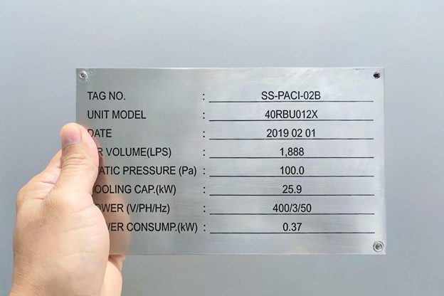 Stainless steel equipment nameplate showing model and specification details