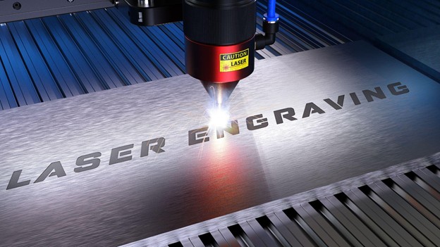 Laser engraving machine marking permanent text on a metal plate